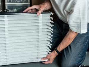 man changing air filter